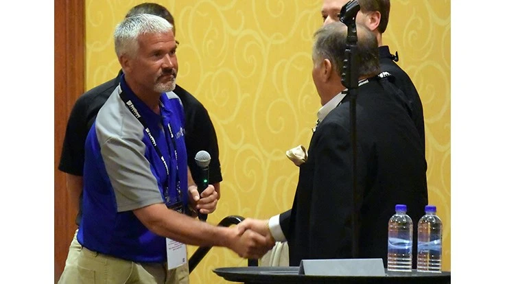 Lawn-Plus General Manager Bob Brower (left) presents the check to Project EverGreen Board Member Fred Haskett.