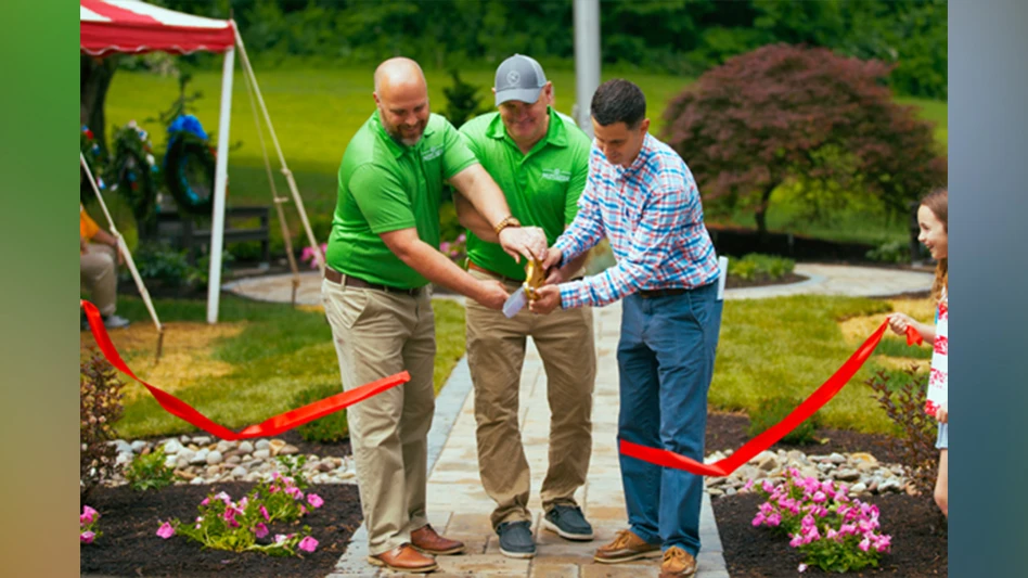 Brad Stephenson helps cut a ribbon