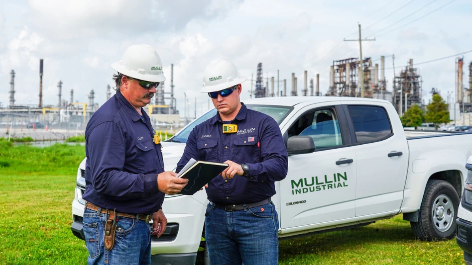 Two Mullin Industrial employees in front of a work truck