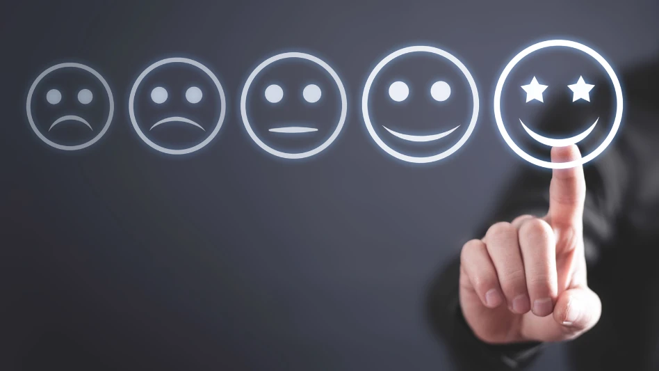 A finger points to an illustration of a smiling emoji